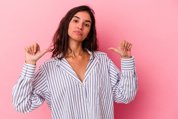 Young caucasian woman isolated on pink background feels proud and self confident, example to follow.