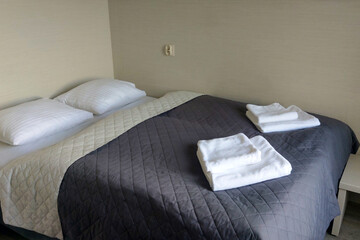 View of the bed with white towels.
