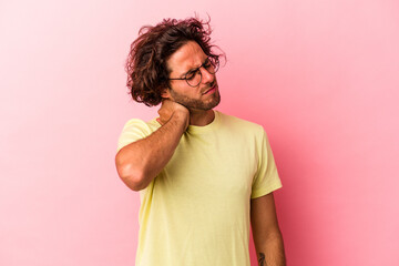 Young caucasian man isolated on pink bakcground having a neck pain due to stress, massaging and touching it with hand.