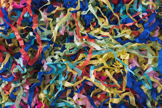 Jumbled background texture of colorful party streamers © sergign