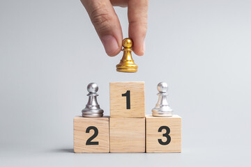 hand holding top of golden chess pawn pieces or leader businessman. victory, leadership, business...
