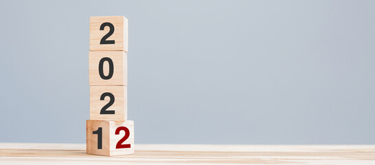 2022 wooden cube blocks on table background. Resolution, plan, review, goal, start and New Year...