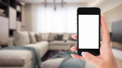 Human hand holding smartphone with white blank empty screen mockup, using smart at home
