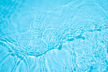 Transparent blue colored clear water surface texture with ripples, splashes and bubbles. Abstract...