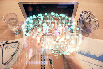 Fototapeta premium Double exposure of man's hands typing over computer keyboard and brain hologram drawing. Top view. Ai and data technology concept.