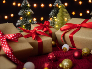 Gift boxes and christmas balls against bokeh lights background.