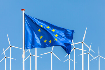 Flag of the European Union in front of a large windpark with wind turbines