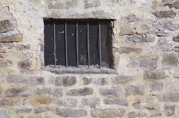 Fototapeta na wymiar Vertical Window Bars on Old Colonial Stone Masonry Mill