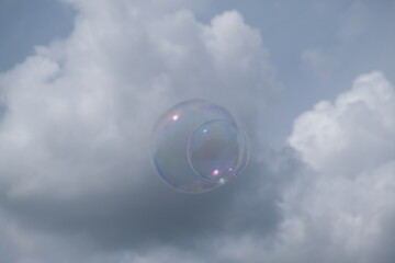 Soap bubbles with clouds in background