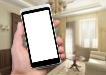 Human hand holding smartphone with white blank empty screen mockup, using smart at home