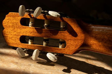 a different view of the guitar strings and handle and tuning phone