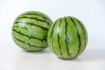 ripe watermelons on a white background and on melons