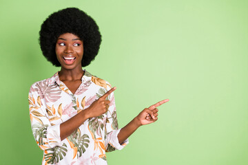 Photo of young black girl happy positive smile indicate fingers empty space select suggest advert...