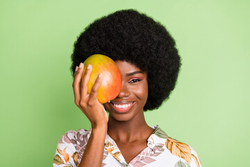Photo of young attractive black girl happy positive smile close cover eye mango food tasty isolated...