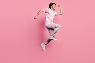 Fototapeta na wymiar Full body profile side photo of young man happy positive smile jump up go walk run isolated over pink color background