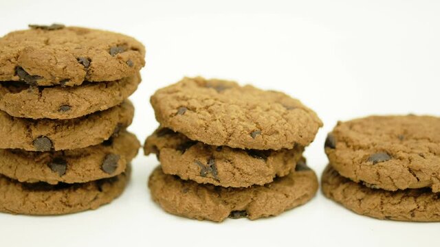 Dolly of rows chocolate chip cookies on white background.