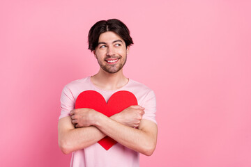 Photo portrait man embracing red paper heart looking copyspace isolated pastel pink color background