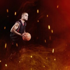 High jumping. Young man, a male basketball player in explosion of fire