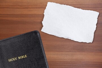 Blank paper on wooden background. Christian biblical concept of belief in God Jesus Christ.