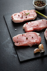 Raw uncooked meat slice on slate