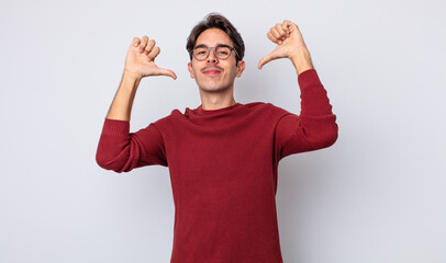 young handsome hispanic man feeling proud, arrogant and confident, looking satisfied and...