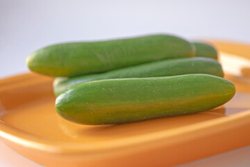 Cucumbers in a dish and isolated on white background