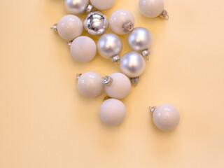 Closeup of Christmas balls on pastel yellow background. new year card. christmas decoration