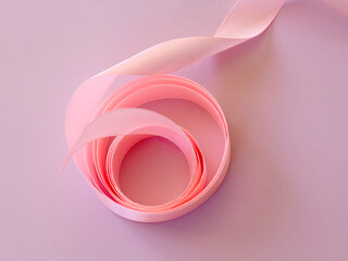 Pink satin ribbon on pink background. greeting card. saint valentine day. mother's day