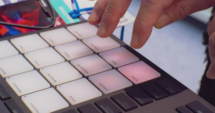 musician pushing buttons of music console. modern digital audio mixer close-up.