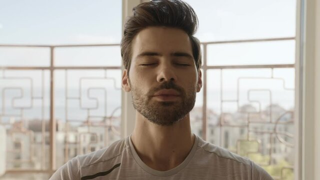 Close-up View Of The Smiling Man Taking A Deep Breath At Home