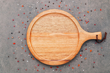 Empty pizza platte with spices set up on dark concrete background flat lay and copy space.