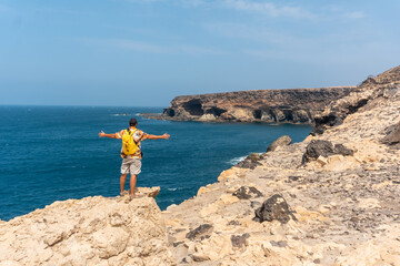 A young tourist on the trail heading to the caves of Ajuy, Pajara, west coast of the island of Fuerteventura, Canary Islands. Spain