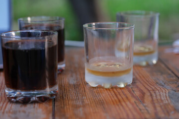Glasses of whiskey and beer are on table in bar closeup