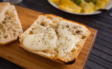 toasted slices of square bread with warm cheese and and provencal herbs on plate breakfast