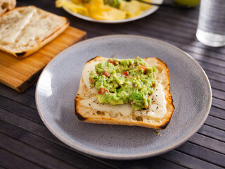 morning toast with melted cheese and guacamol