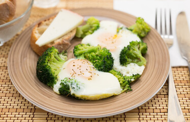 breakfast of crumpled eggs with broccoli