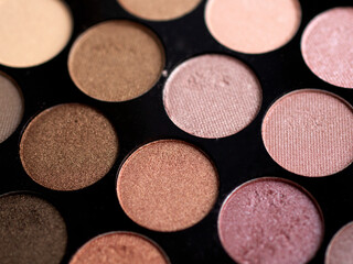 Fototapeta premium Make-up eye shadow palette close up. Professional multicolor eyeshadow palette. Makeup. Professional multicolor eyeshadow make up palette background. Colorful bright eye shadows set backdrop