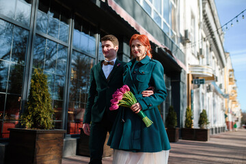 beautiful young couple walking along the city street