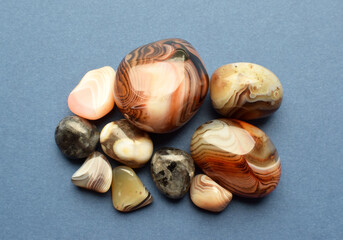 Multicolored gemstones, tumbled minerals. Agates of various sizes. Bostwan agate