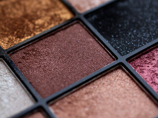 Make-up eye shadow palette close up. Professional multicolor eyeshadow palette. Makeup. Professional multicolor eyeshadow make up palette background. Colorful bright eye shadows set backdrop