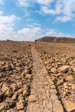 Beautiful stone path to the Crater of the Calderon Hondo volcano near Corralejo, north coast of the island of Fuerteventura, Canary Islands. Spain
