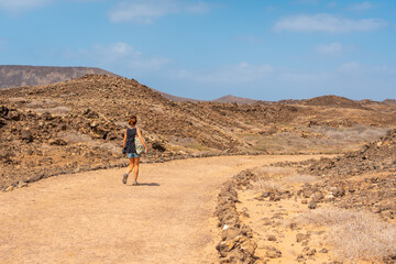 A young tourist visiting the Isla de Lobos, off the north coast of the island of Fuerteventura, Canary Islands. Spain