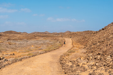 A young tourist visiting the Isla de Lobos, off the north coast of the island of Fuerteventura, Canary Islands. Spain