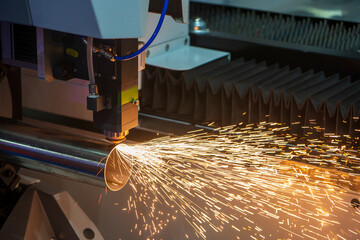 The fiber laser cutting machine cutting the stainless steel tube control by CNC program.