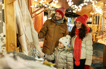 family, winter holidays and celebration concept - happy mother, father and little daughter at...