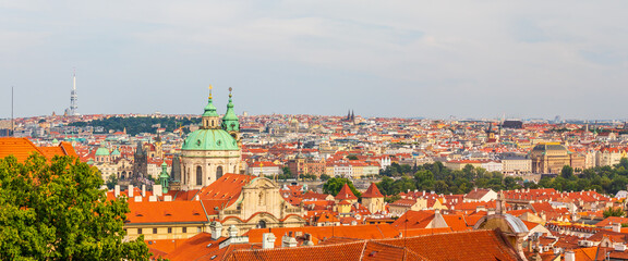 Naklejka na ściany i meble Prague cityscape panorama - city landscape with Towers of the Church of Saint Nicholas, Czech republic