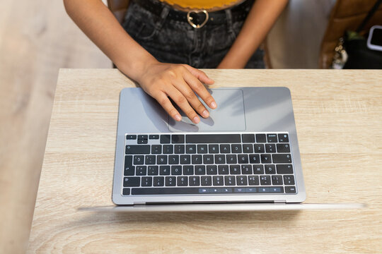 Anonymous woman typing on laptop during workday