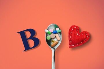 Vitamin B complex with a spoon of pills on the desk