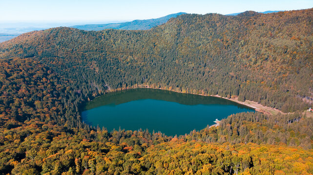 Aerial  drone panorama view of the fall season over Saint Anne (Sfanta Ana) volcanic lake. Forest and water. Harghita, Romania, in autumn