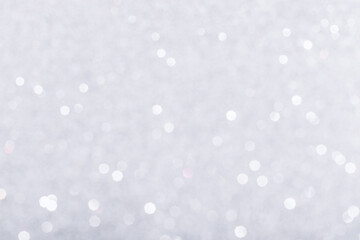 Silver glowing sparkles blurred background